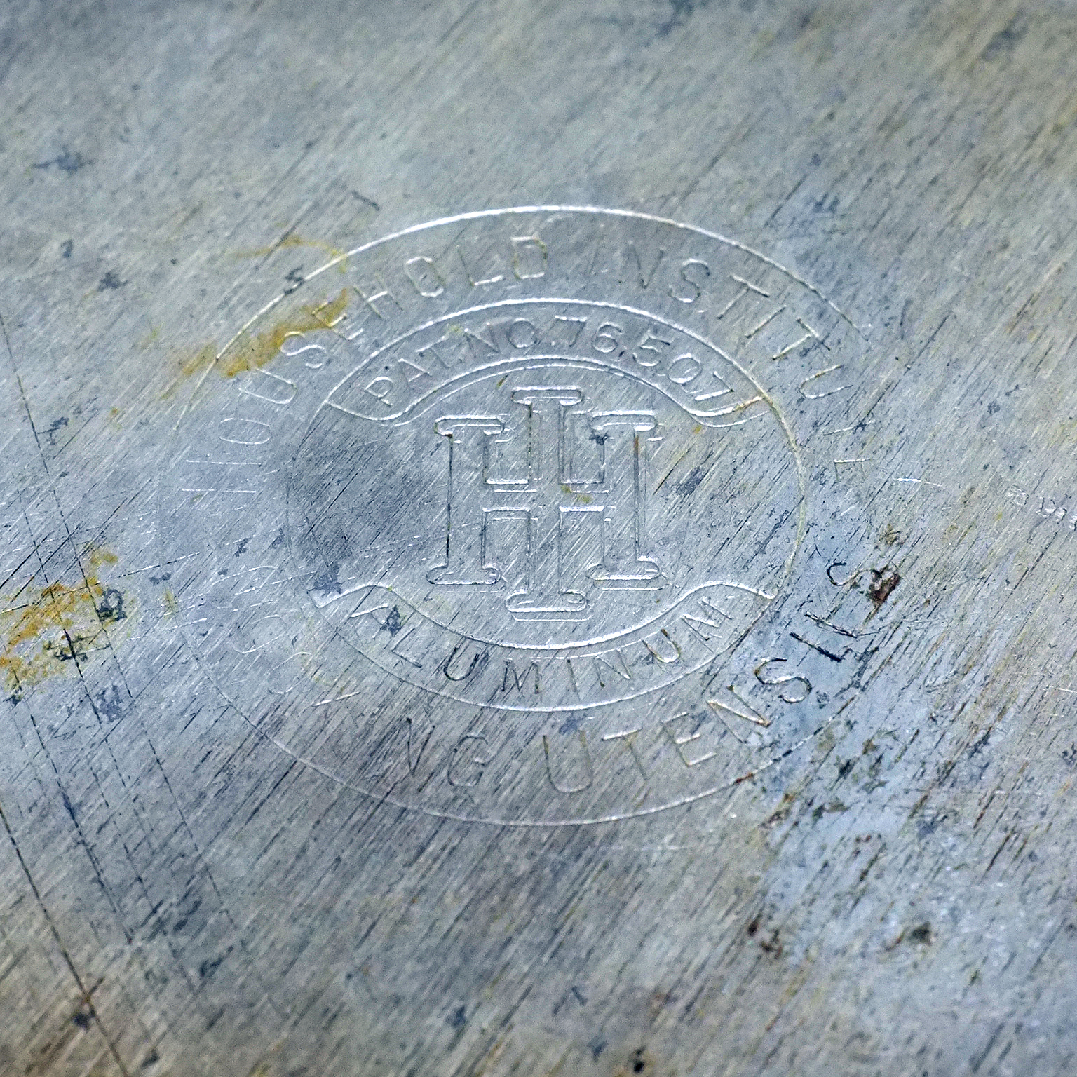 Household Institute Cooking Utensils — patent 76,507, aluminum Stamped bottom of the pot: circular embossed mark — HOUSEHOLD INSTITUTE / PAT. NO. 76,507 / twin-H monogram / ALUMINUM / COOKING UTENSILS