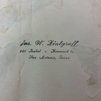 Reverse of one of the prints, showing the photographer's studio stamp: "Jas. W. Zintgraff. 131 Isabel - Kenwood 6, San Antonio, Texas" in flowing script over the creased cream paper back.